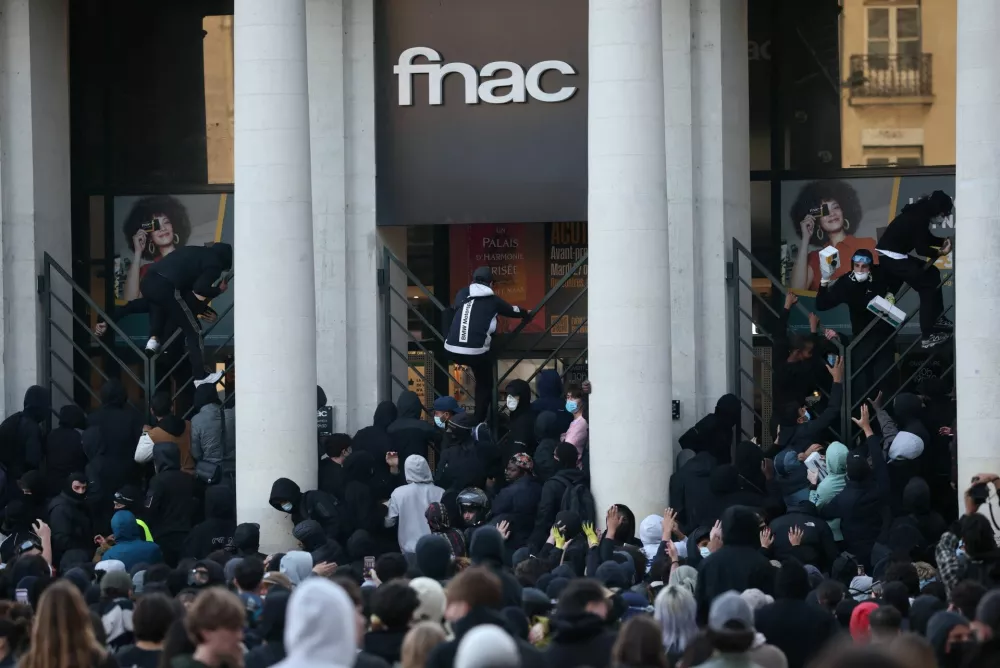 Protesters climb fences during a demonstration as part of nationwide protests called by the "Yellow Vests" movement against the cost of living and rising fuel prices, joined by French high school and university students, teachers and parents demanding better school conditions and government action, as well as labour unions, workers, farmers and retirees, in Nantes, France, October 17, 2026. REUTERS/Stephane Mahe