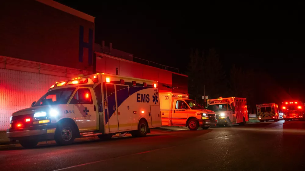 Emergency crews and military personnel gather at the Wainwright Health Centre as injured military members are treated after a fire at Canadian Forces Base Wainwright, outside of Wainwright, Alberta Saturday, Oct. 17, 2026. (John Ulan/The Canadian Press via AP)