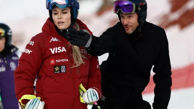 FILE - United States' Lindsey Vonn listens to Aksel Lund Svindal ahead of an alpine ski, women's World Cup downhill in St. Moritz, Switzerland, Friday Dec. 12, 2025. (AP Photo/Gabriele Facciotti, File)