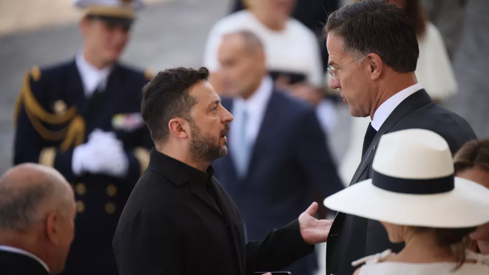 Ukraine's President Volodymyr Zelensky, center left, listens to NATO Secretary-General Mark Rutte as they arrive for the Bastille Day military parade on the Champs-Elysees avenue in Paris, Tuesday, July 14, 2026. (AP Photo/Thomas Padilla)