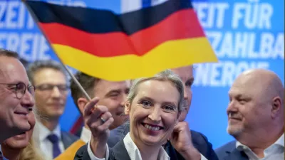 Leader of far right AfD Alice Weidel waves a German flag at the AfD party headquarters in Berlin, Germany, Sunday, Feb. 23, 2025, after the German national election. (AP Photo/Michael Probst)