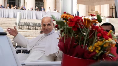 Pope Leo XIV is presented with flowers as he leaves at the end of the general audience in St. Peter's Square at The Vatican, Wednesday, Oct. 21, 2026. (AP Photo/Gregorio Borgia)