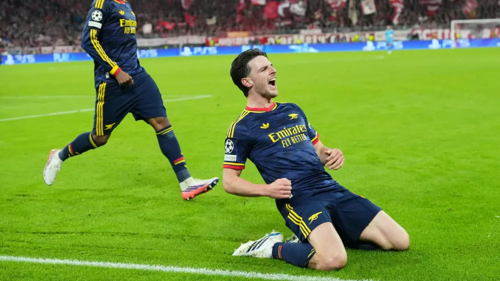 Arsenal's Declan Rice celebrates after scoring his side's second goal during the UEFA Champions League soccer match between Bayern Munich and Arsenal in Munich Germany, Wednesday, Oct. 21, 2026. (AP Photo/Martin Meissner)