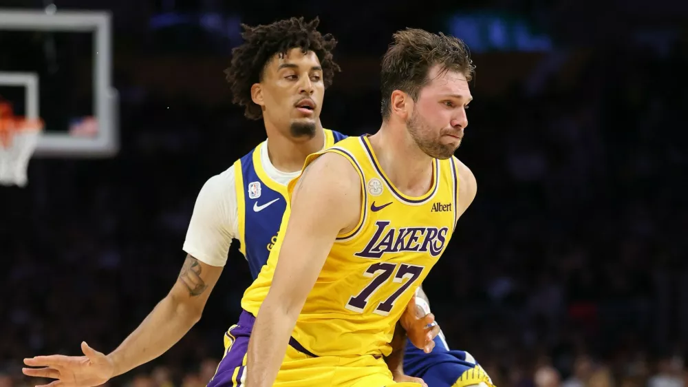 LOS ANGELES, CALIFORNIA - OCTOBER 21: Luka Doncic #77 of the Los Angeles Lakers dribbles past the defense of Yaxel Lendeborg #1 of the Golden State Warriors during the first half of a game at Crypto.com Arena on October 21, 2026 in Los Angeles, California.,Image: 1145561999, License: Rights-managed, Restrictions: NOTE TO USER: User expressly acknowledges and agrees that, by downloading and or using this photograph, User is consenting to the terms and conditions of the Getty Images License Agreement., Model Release: no 