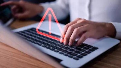 Error and maintenance concept. Businessman or it staff, programmer, developer using computer laptop with triangle caution warning sign for notification.
