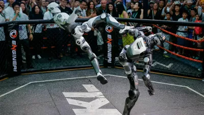 Robots fight during an MMA-style performance at Engine AI booth at the 2026 World Robot Conference, in Beijing, China, August 19, 2026. REUTERS/Maxim Shemetov Purchase Licensing Rights