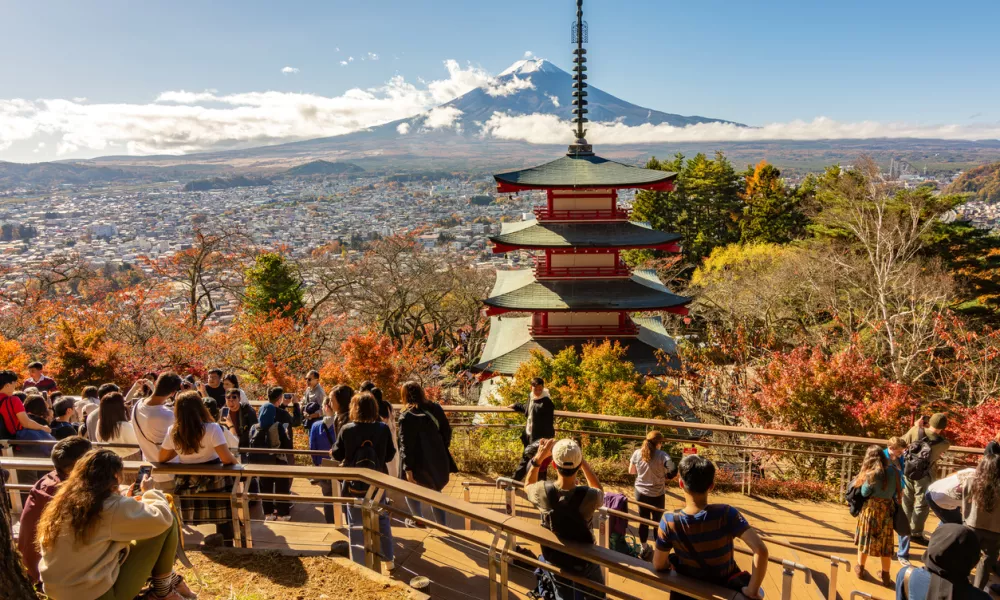 Arakura, Japan - 17 November 2024: People at Chureito Pagoda in autumn with Mount Fuji at background
