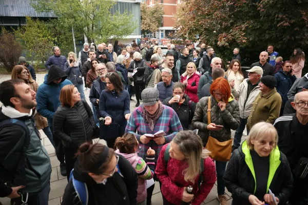 People wait outside a polling station before the start of voting in a parliamentary election in Novi Sad, Serbia, Sunday, Oct. 25, 2026. (AP Photo/Armin Durgut)