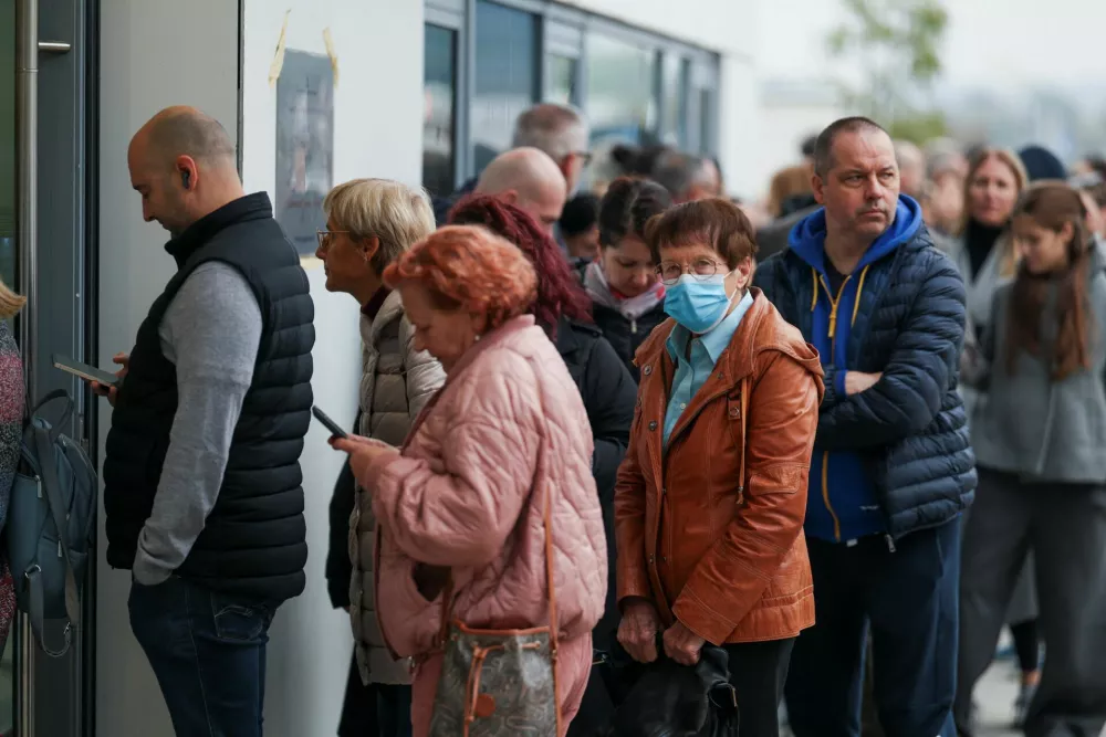 People queue outside a polling station to cast their votes during the parliamentary election in Belgrade, Serbia, October 25, 2026. REUTERS/Marko Djurica
