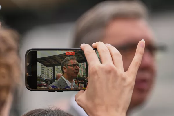 A person records video of Aleksandar Vucic, leader of the right-wing Serbian Progressive Party (SNS), speaking to media after voting in a parliamentary election in Belgrade, Serbia, Sunday, Oct. 25, 2026. (AP Photo/Darko Vojinovic)