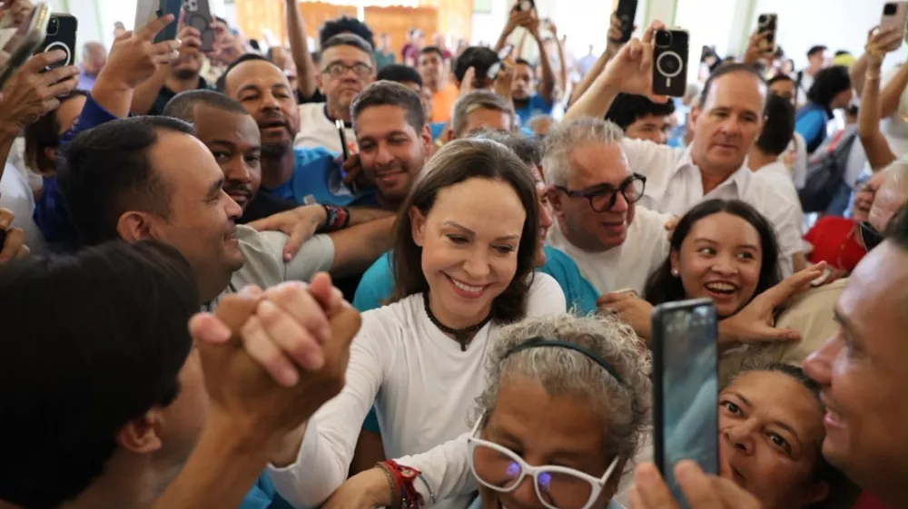 In this photo released by Vente Venezuela Press Office, Venezuelan opposition leader Maria Corina Machado greets supporters at a church in Barquisimeto, Venezuela, Sunday, Oct. 25, 2026. (Vente Venezuela Press Office via AP)
