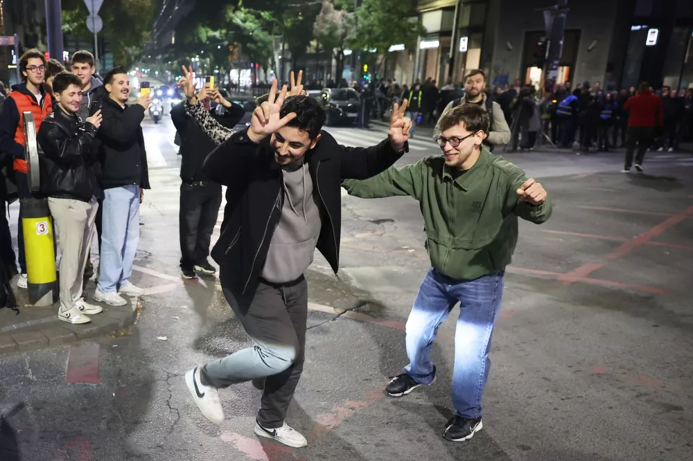 Youngsters celebrate after polls closed in the parliamentary election in Belgrade, Serbia, Sunday, Oct. 25, 2026. (AP Photo/Armin Durgut)