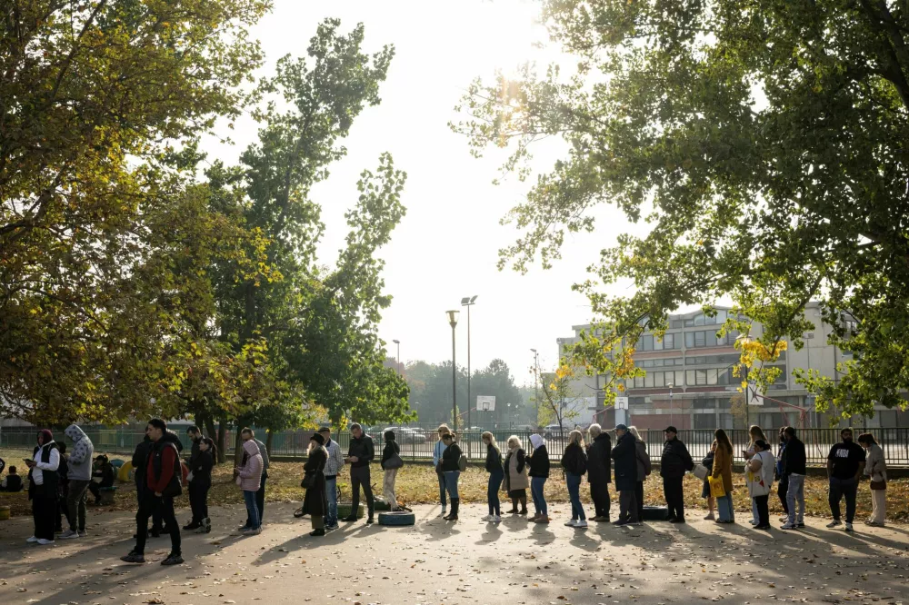 People queue outside a polling station to vote during the parliamentary election in Belgrade, Serbia, October 25, 2026. REUTERS/Marko Djurica
