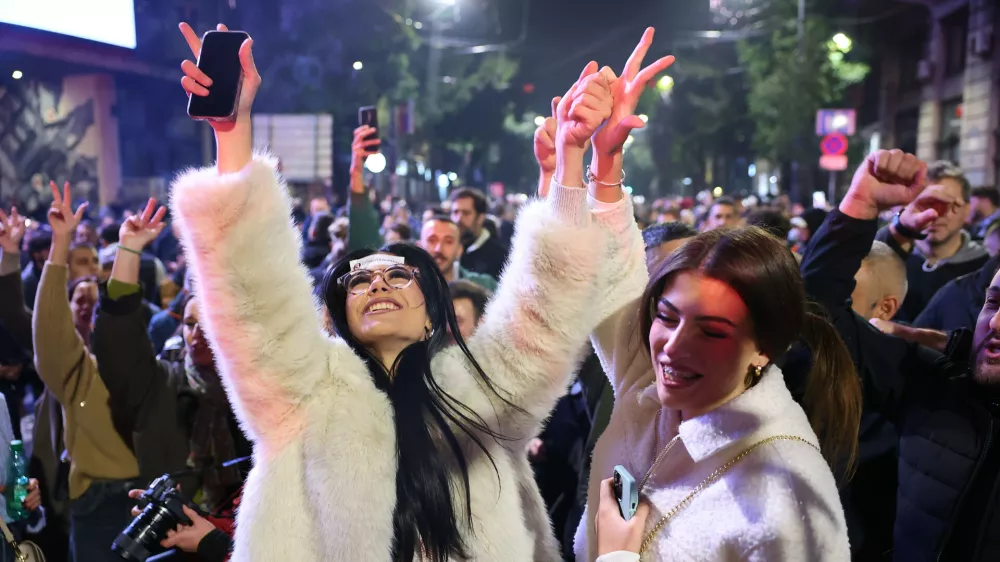 People celebrate after Aleksandar Vucic, leader of the right-wing Serbian Progressive Party (SNS) conceded defeat in the parliamentary election in Belgrade, Serbia, Sunday, Oct. 25, 2026. (AP Photo/Armin Durgut)