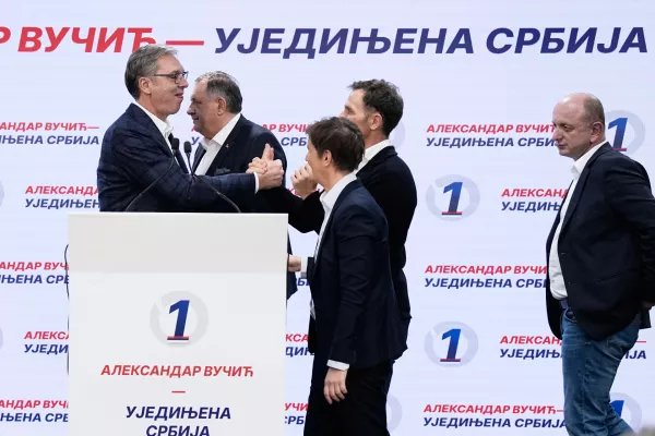 Aleksandar Vucic, leader of the right-wing Serbian Progressive Party (SNS) shakes hands with party members after conceding defeat in the parliamentary election in Belgrade, Serbia, Sunday, Oct. 25, 2026. (AP Photo/Darko Vojinovic)