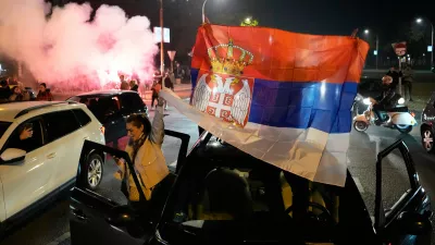 People celebrate after Aleksandar Vucic, leader of the right-wing Serbian Progressive Party (SNS) conceded defeat in the parliamentary election in Belgrade, Serbia, Sunday, Oct. 25, 2026. (AP Photo/Darko Vojinovic)
