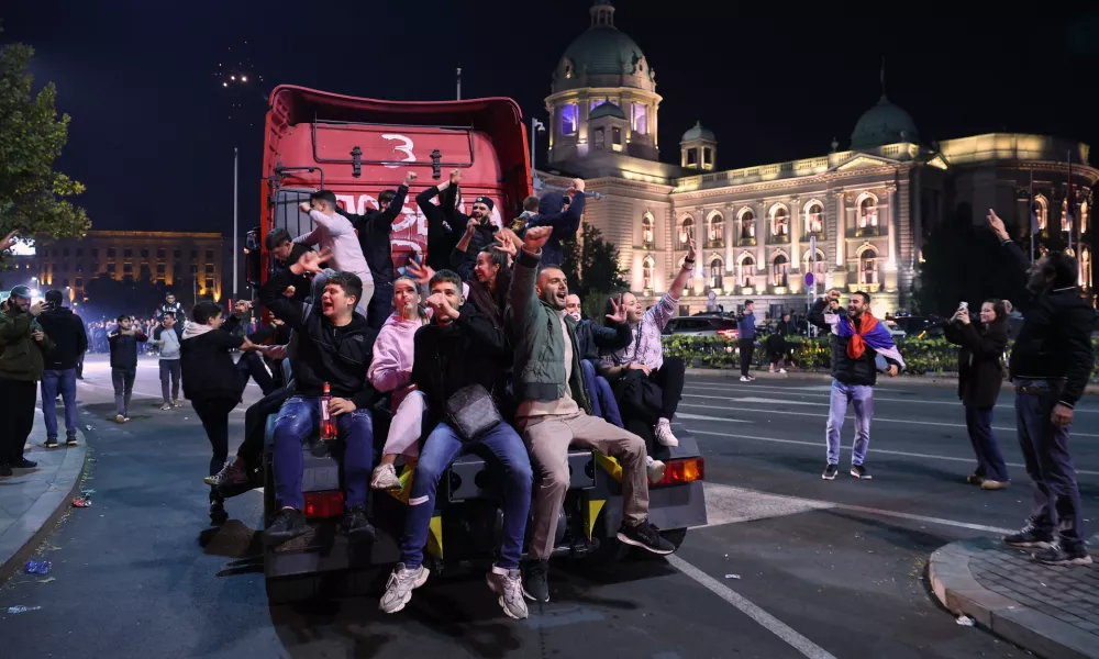 People celebrate outside the National Assembly, after Aleksandar Vucic, leader of the right-wing Serbian Progressive Party (SNS) conceded defeat in the parliamentary election in Belgrade, Serbia, early Monday, Oct. 26, 2026. (AP Photo/Armin Durgut)