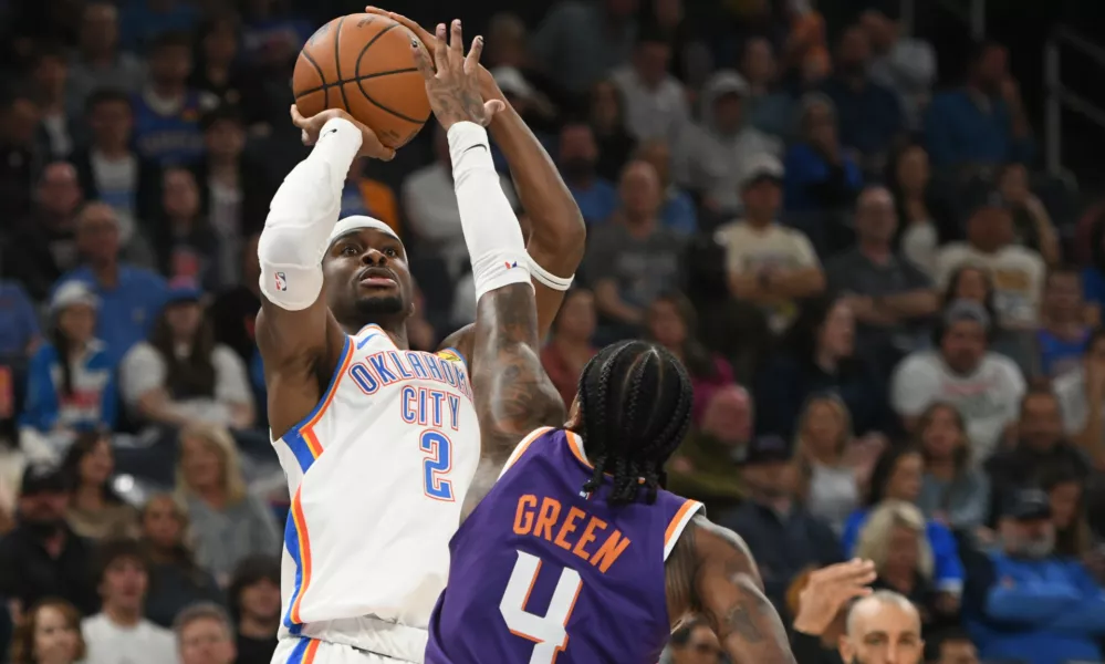 Oklahoma City Thunder guard Shai Gilgeous-Alexander (2) looks to shoot over Phoenix Suns guard Jalen Green (4) during the second half of an NBA basketball game, Monday, Oct. 26, 2026, in Oklahoma City. (AP Photo/Kyle Phillips)
