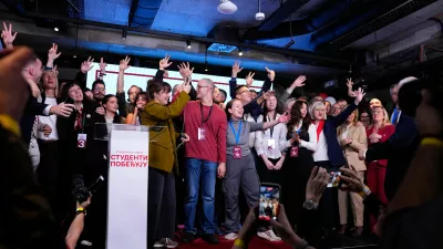 Candidate of the Students' List celebrate on stage along with staff members after polls closed in the parliamentary election in Belgrade, Serbia, Sunday, Oct. 25, 2026. (AP Photo/Petr David Josek)