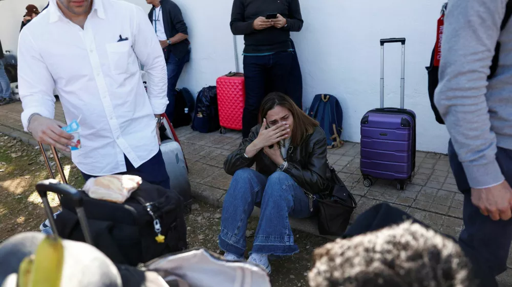 A survivor reacts while waiting to board a bus outside the municipal center where they have been taken, following the collision of two high-speed trains between the towns of Mora and Orgaz, in Urda, Spain, October 28, 2026. REUTERS/Susana Vera