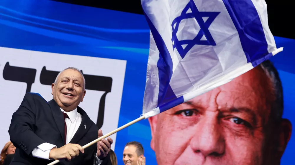 Former military chief Gadi Eisenkot, leader of the Yashar party, waves an Israeli flag following the exit polls at his party headquarters, on the evening of Israel's national election, in Tel Aviv, Israel October 28, 2026. REUTERS/Shir Torem   TPX IMAGES OF THE DAY