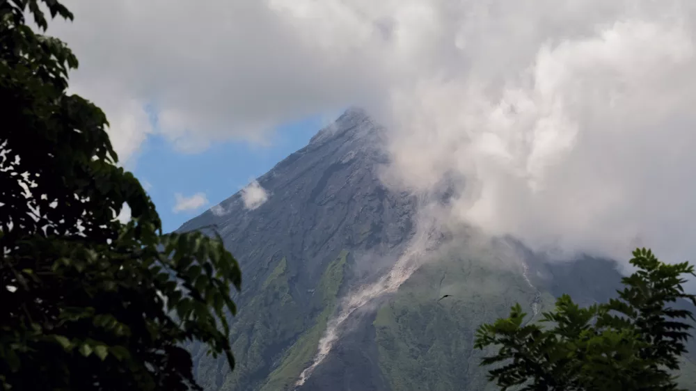 Mayon Volcano spews white smoke as seen from Daraga, Albay province, central Philippines on Thursday June 8, 2023. The Philippine Institute of Volcanology and Seismology raised Thursday the status of Mayon Volcano in Albay to Alert Level 3 due to "increased tendency towards a hazardous eruption." (AP Photo/John Michael Magdasoc)
