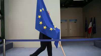 A person carries the EU flag during a NATO leaders summit in Vilnius, Lithuania July 12, 2023. REUTERS/Kacper Pempel